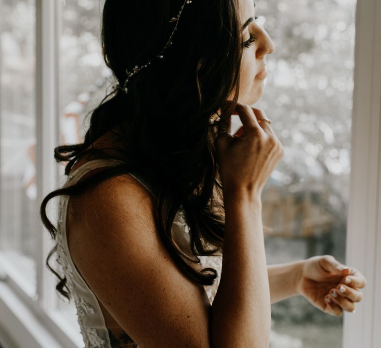 Dark haired bride gets ready on the morning of her wedding