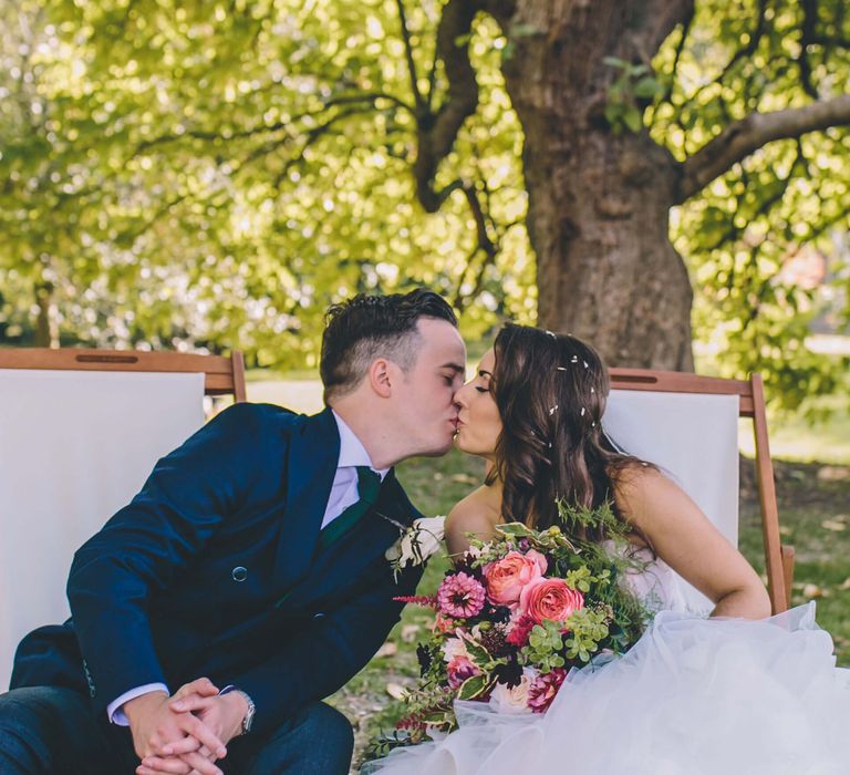 Orleans House Gallery Wedding Inspiration - bride and groom kissing with bride wearing red shoes contrasting with her white fishtail bridal gown