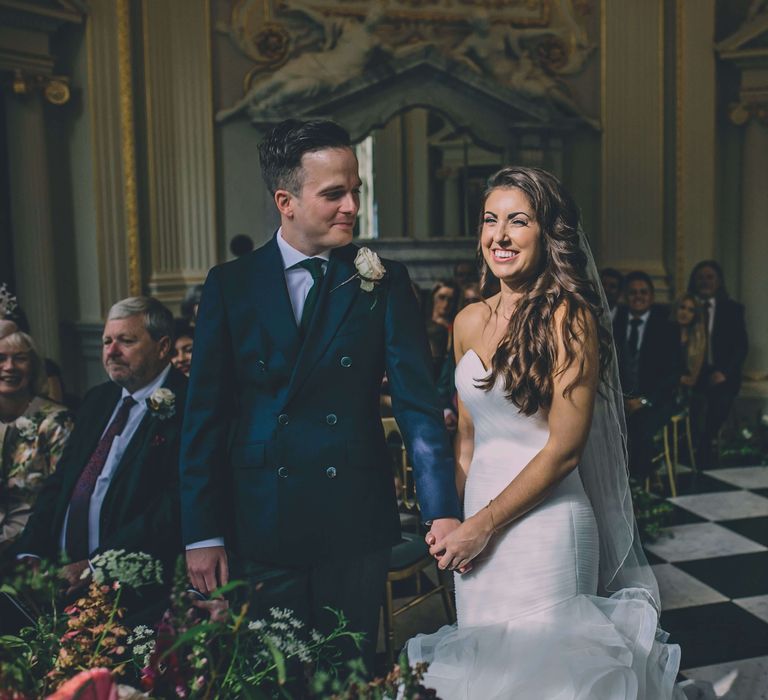 Bride and groom holding hands at Orleans House Gallery wedding