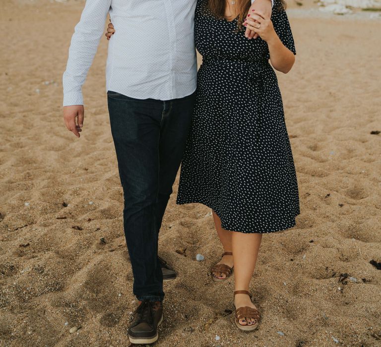 Groom to be holding his finance on Dorset beach 