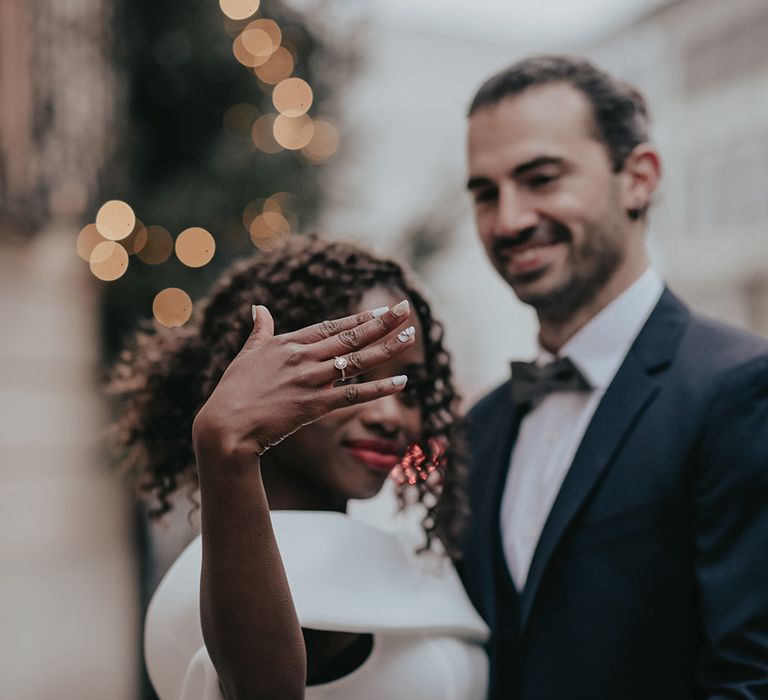 Bride shows off her engagement ring during wedding