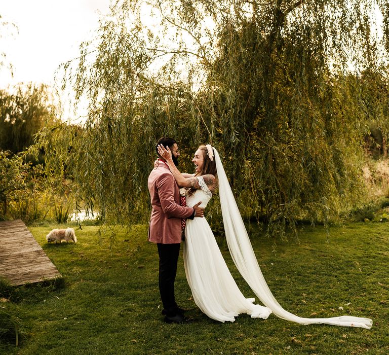 Bride & groom embrace after wedding ceremony in the garden