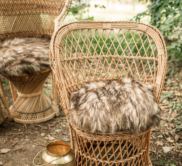 Wicker chair with fur pillow in grey and black