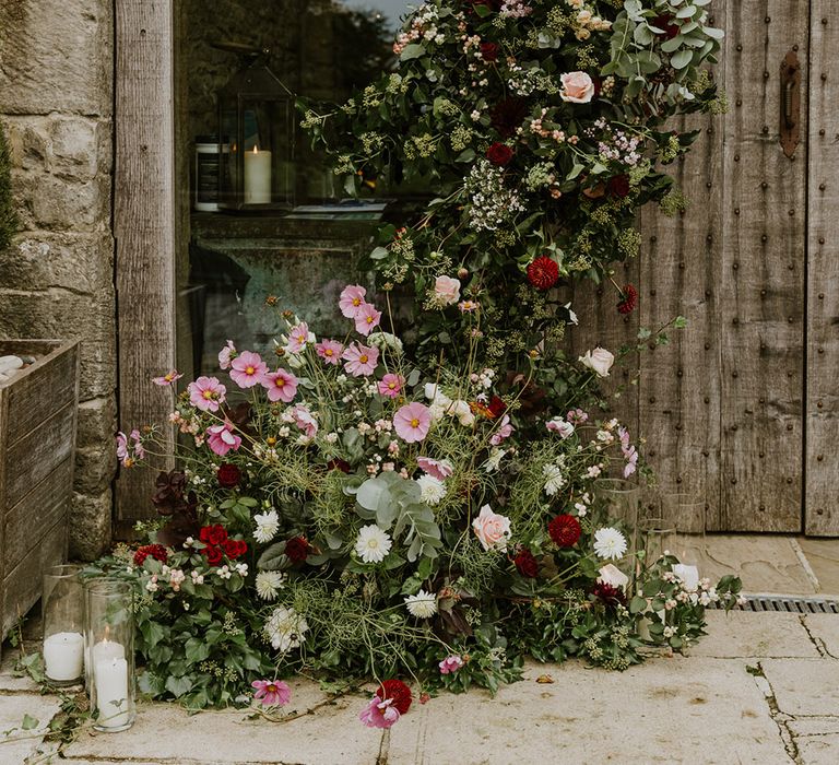 Natural wedding flower doorway arrangement with foliage and wildflowers 