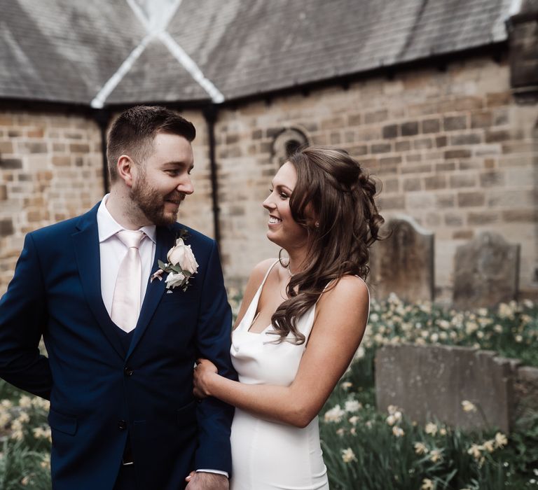 Bride and groom sharing a moment outside the church