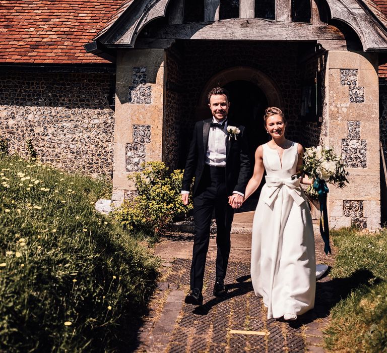 Bride & groom leave church on their wedding day