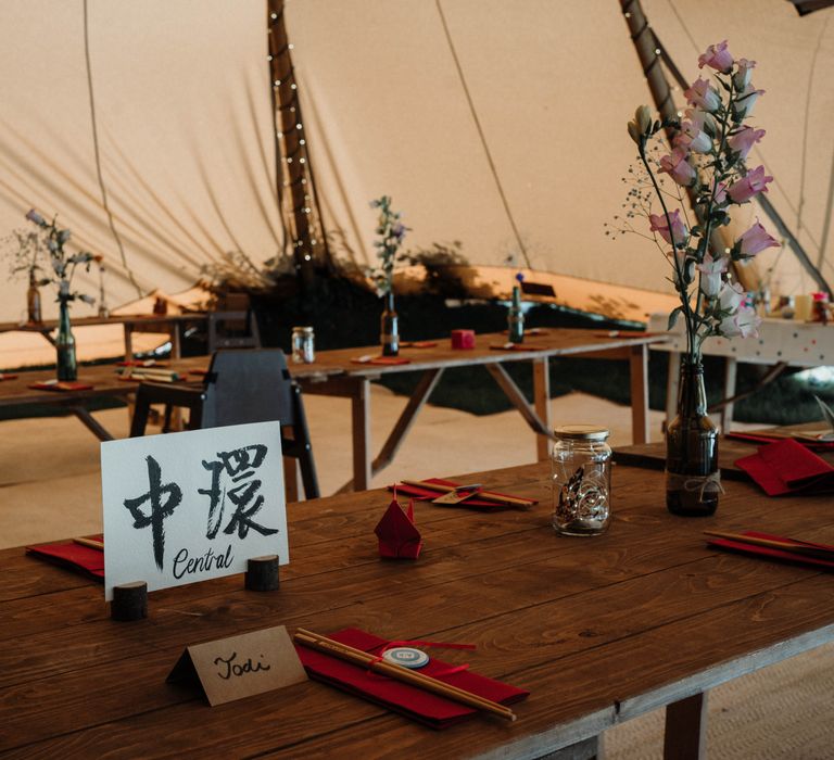 Rustic tipi wedding complete with calligraphy Chinese table settings and homemade floral arrangements 