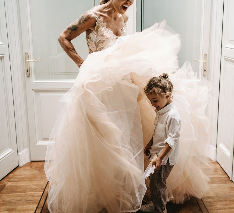 Little boy stands beside his mother on her wedding day