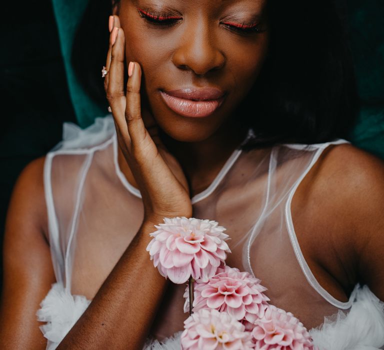 Black bride with light pink eyeliner and lipgloss wedding makeup 