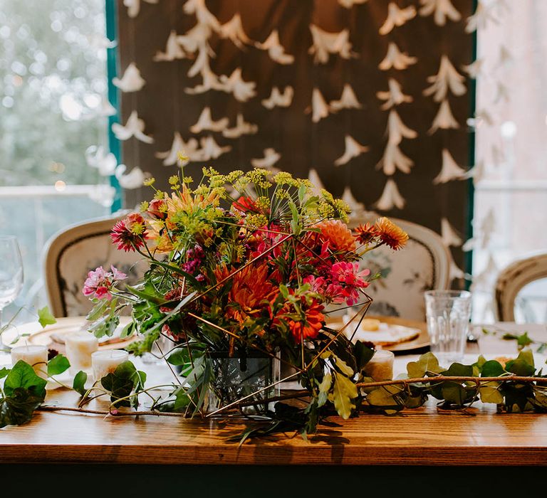 Brightly coloured floral bouquet on wooden table 