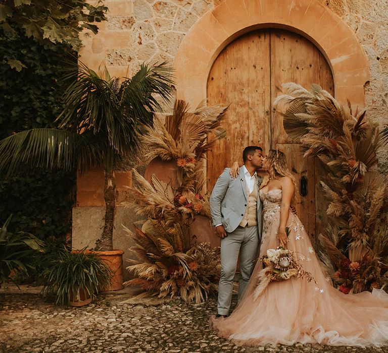 Bride leans in to groom on her wedding day