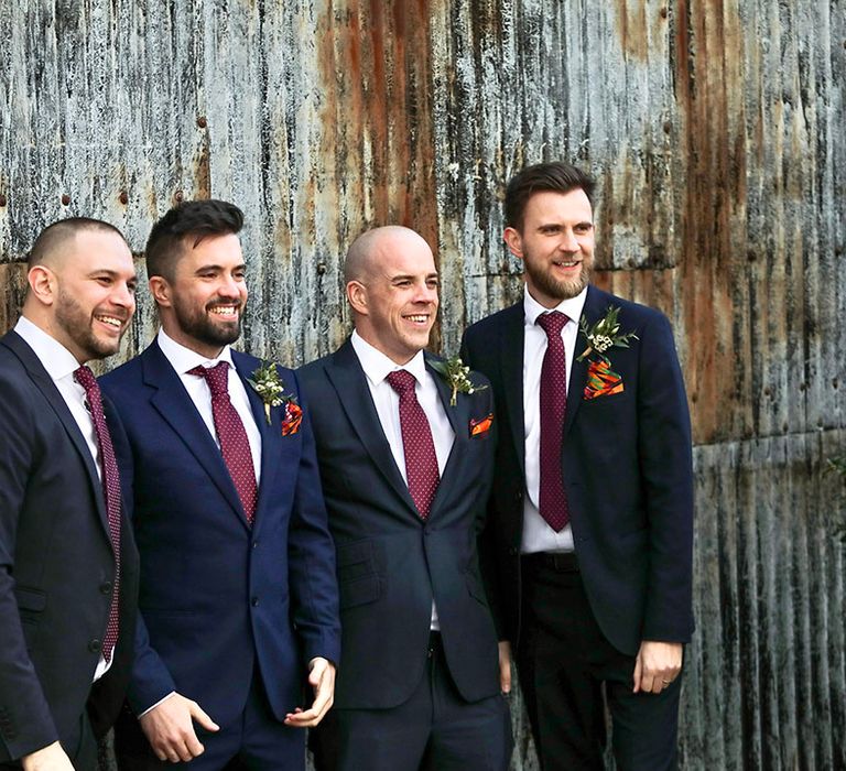 Groom stands with his groomsmen outdoors