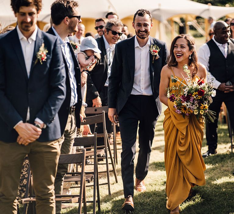 Bride & groom walk together on their wedding day