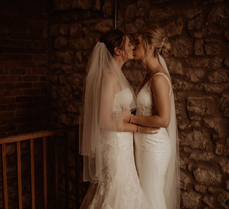 Brides kiss on their wedding day outdoors 