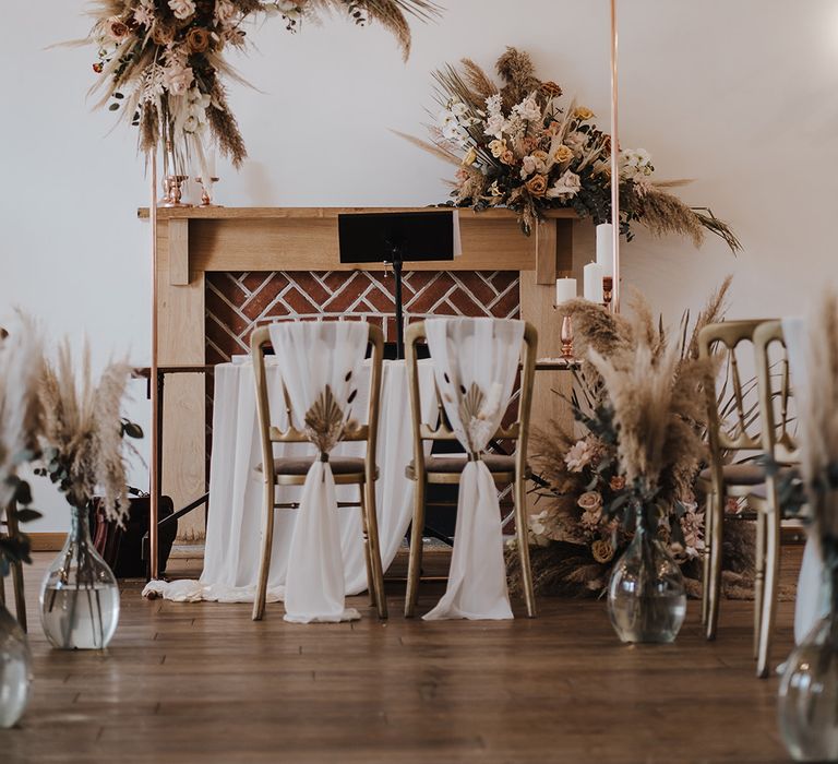 Burley Manor wedding venue decorated with copper arch, candle holders, dried flowers and fairy lights for boho luxe vibe