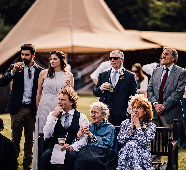 Wedding guests listen to wedding speeches