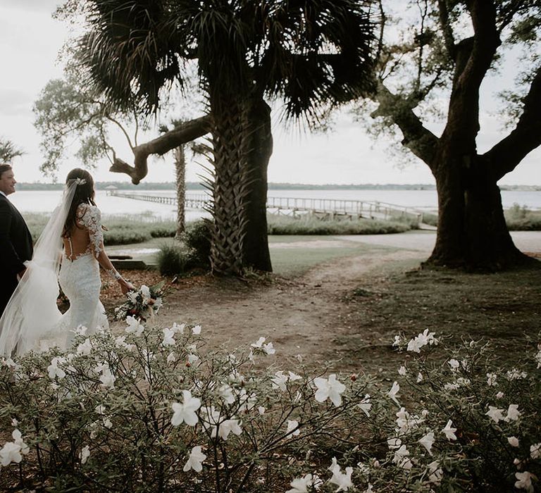 Bride and groom walk around their wedding venue together 