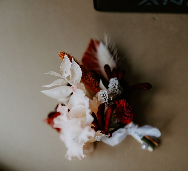 Red, orange and white dried flower decorations with peonies and pampas grass 