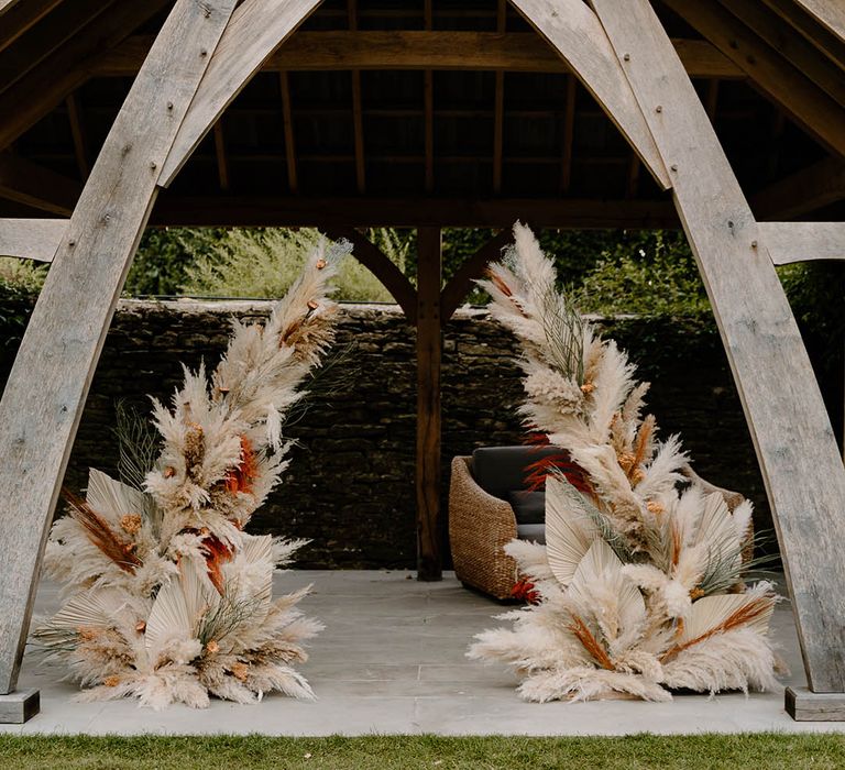 Pampas grass wedding column flower arrangements with dried leaves for barn wedding 