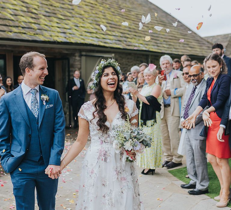 Confetti moment at The Tithe Barn Bolton Abbey with Indian bride in a Savin London Amelia dress and groom a blue suit