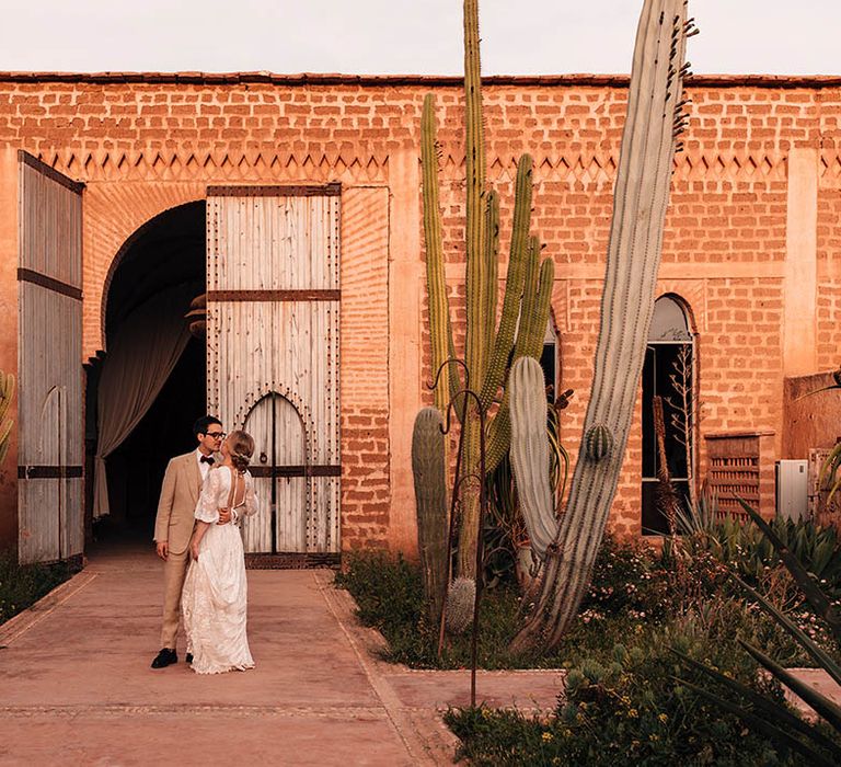 Beldi Country Club wedding venue with cacti with the bride and groom posing for their couple portraits 