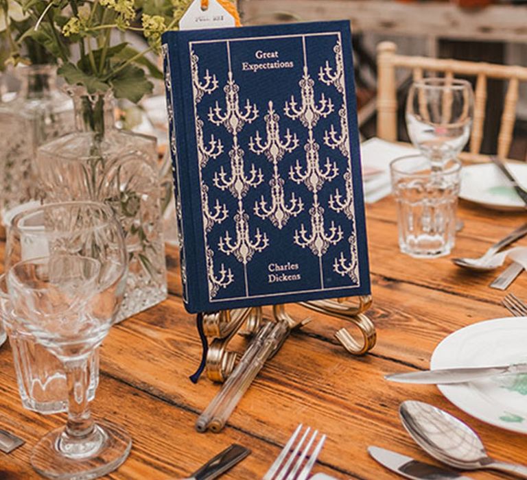 Book lover bride and groom have the Penguin classic clothbound books as their table names 