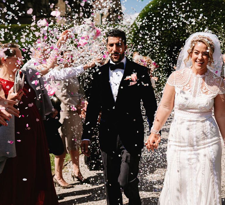 Confetti exit for the bride and groom as they exit from their luxury wedding ceremony 