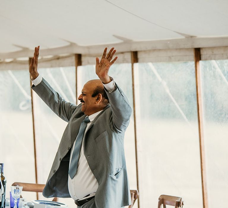 Father of the bride performs his wedding speech with funny animated movement 