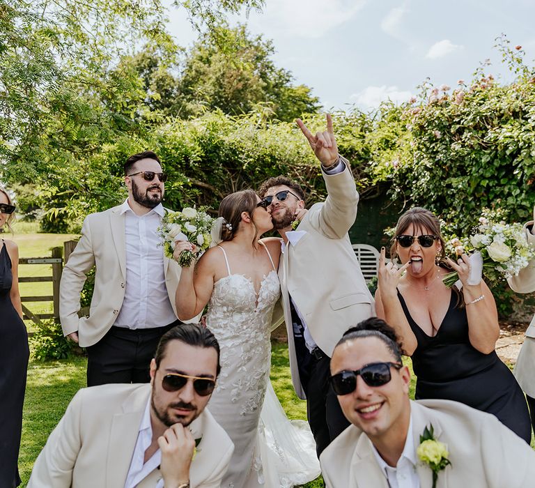 The wedding party in black and white wedding outfits wearing stylish black sunglasses 