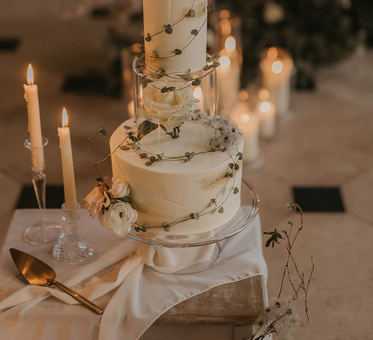 Two tier white wedding cake topper with short glass spacer with white rose and foliage 