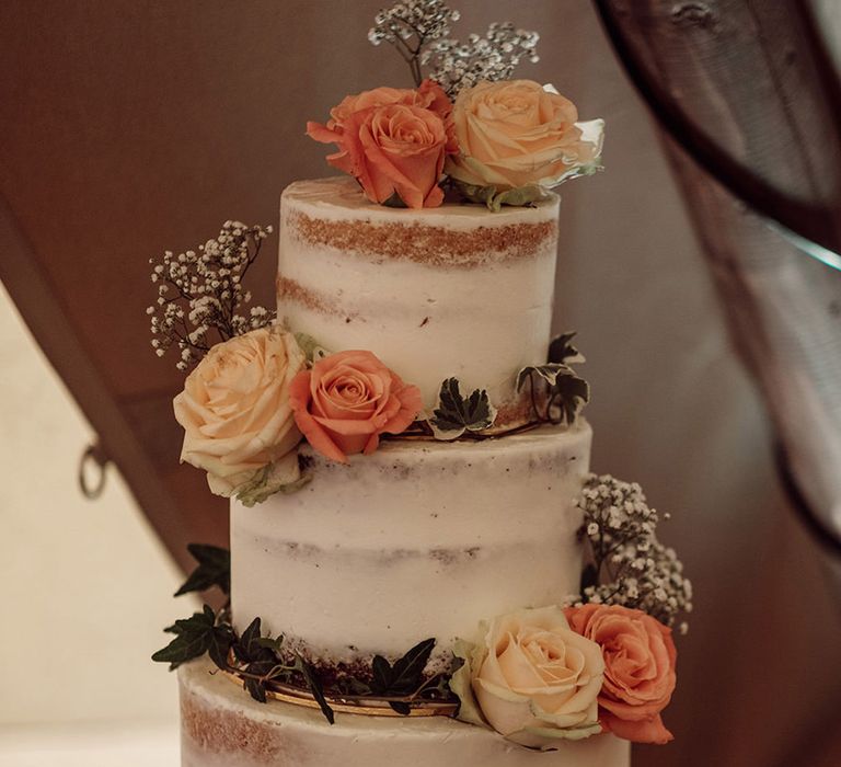 Three tier rustic semi-naked wedding cake with peach rose wedding flower cake decorations 