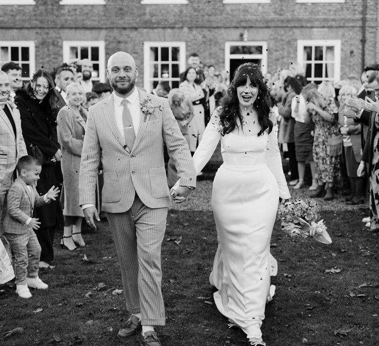 Black and white confetti moment for the bride and groom 