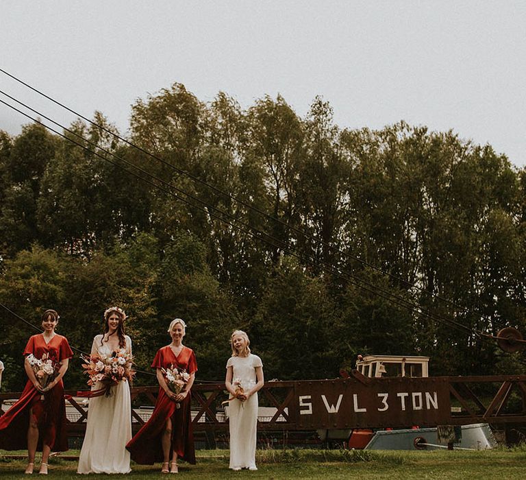 Bridal party wearing burnt orange bridesmaid dresses for autumnal wedding in October 