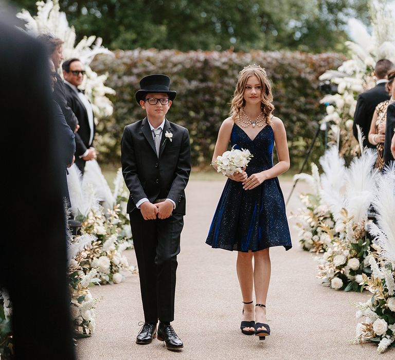 Page boy and flower girl walks down the aisle 