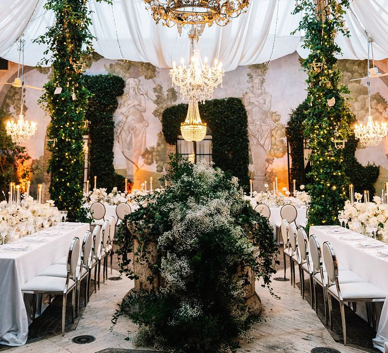 Castello di Torcrescenza wedding venue with foliage and chandeliers with white wedding theme