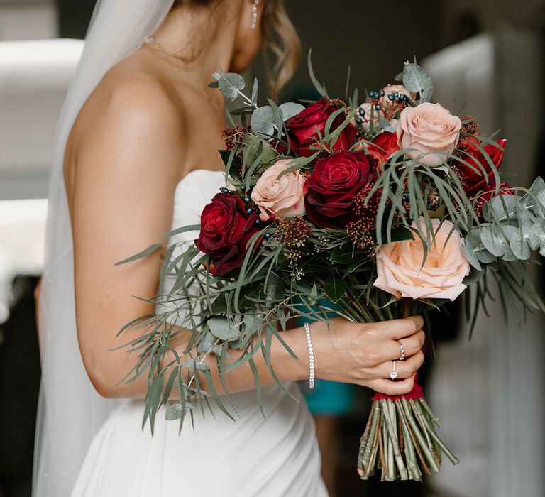 Pink and red rose wedding bouquet for the bride's magical winter wonderland castle wedding 