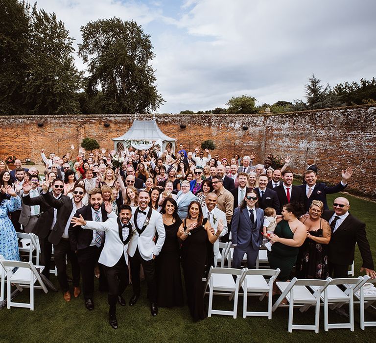 Wedding guests at the wedding ceremony posing together for big group photo 