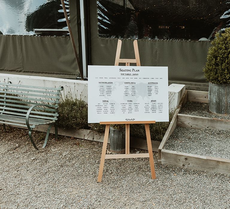 Traditional wedding seating chart signage on wooden easel 