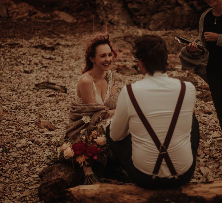 Groom in shirt and braces for beach elopement