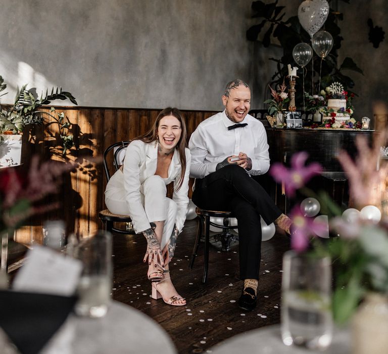 Bride and groom laughing during the pub wedding reception 