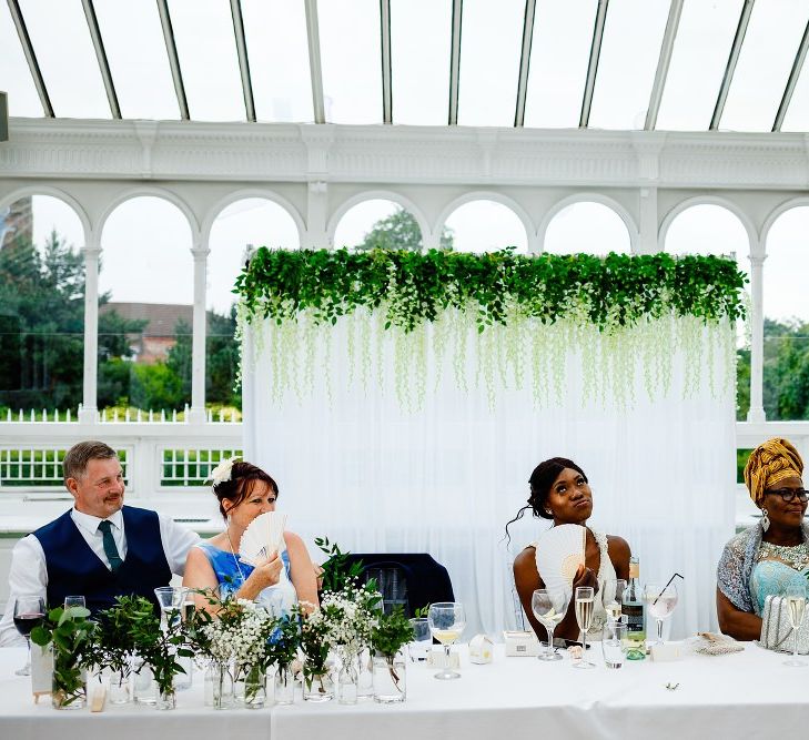 Top table backdrop with fabric and flowers 