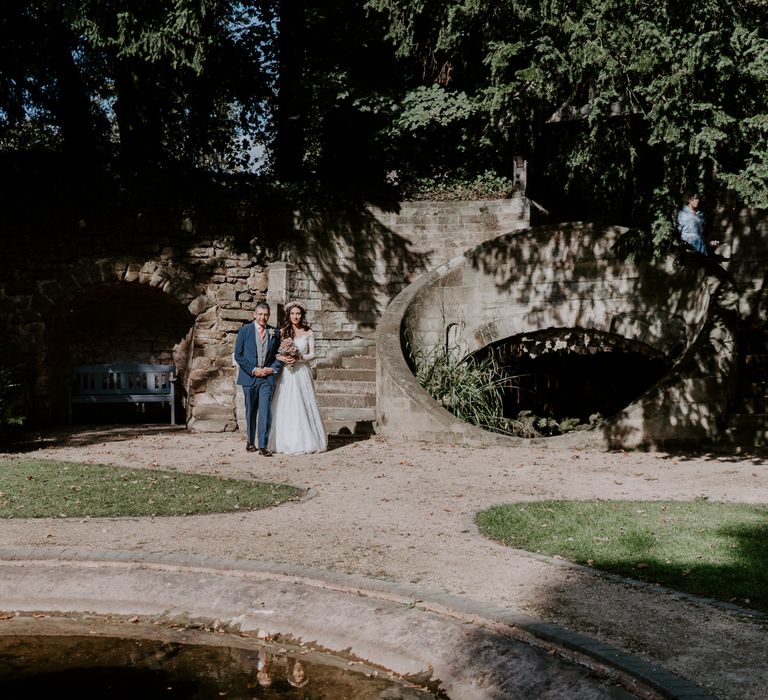 Bride walks with her dad to wedding ceremony wearing ASOS bridal dress