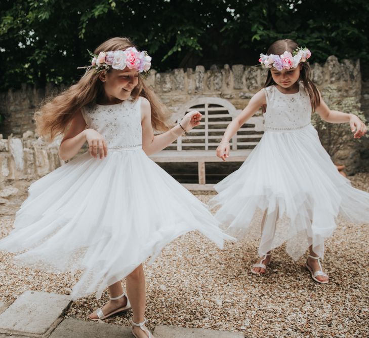 Flower girl twirls with flower crown in hair