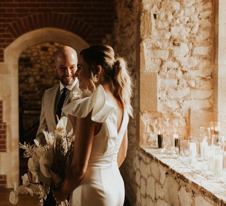 Bride and groom walking down the aisle together at their intimate wedding 