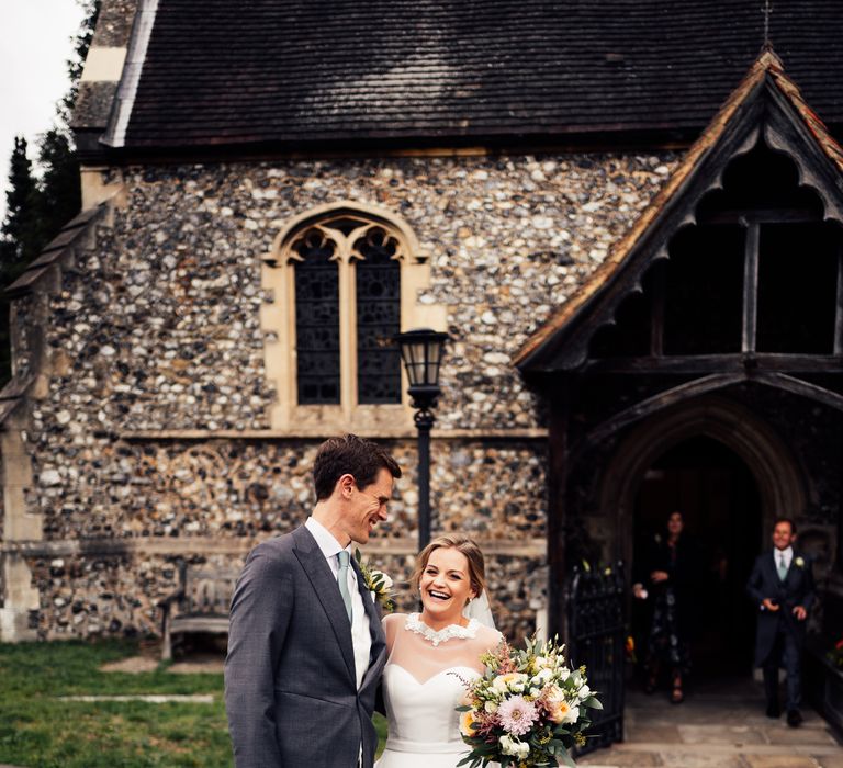 Bride & groom laugh together on wedding day