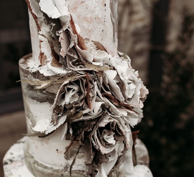 White and brown wedding cake with marble design and ruffle front 