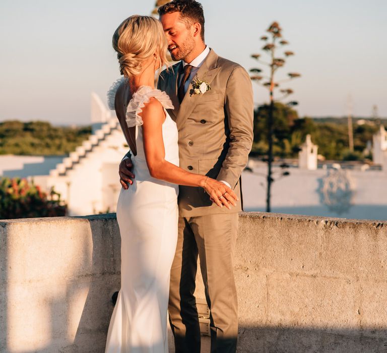 The bride and groom share a kiss at golden hour