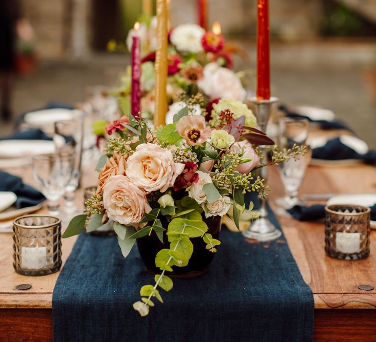 Red, yellow and pink tapered candlesticks for an intimate wedding dinner at a Tuscany elopement