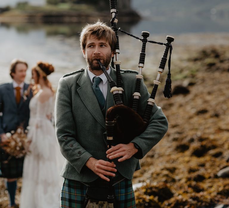 Bagpipes played as bride & groom stand in the background