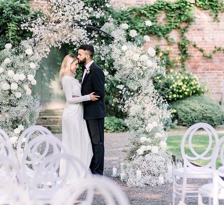 Bride and groom embracing at a sophisticated summer wedding at Garthmyl wedding venue 